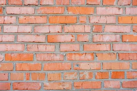 Texture of weathered red brick wall in urban setting Stock Photos