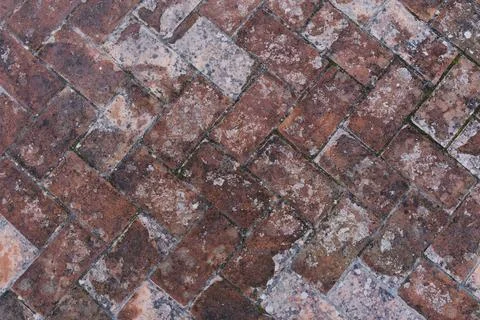 Texture of weathered, warn sidewalk with rectangle pieces of bricks Foto stock