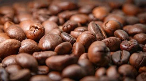 Texture of well-roasted coffee beans in warm colors Stock Photos