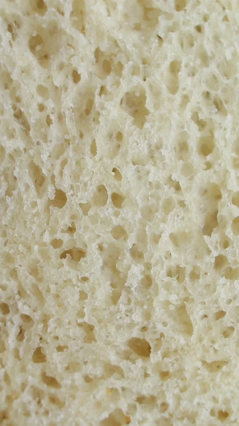 Texture of white bread rotating extreme close up, macro shot. Vertical video. Stock Footage 269312501