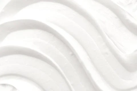 Texture of white cosmetic cream. Moisturizing cream background for dry skin.. Stock Photos