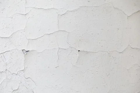 Texture of a white old wall with cracks and peeled paint Stock Photos