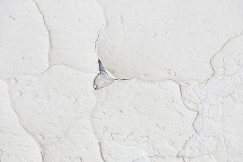 Texture of a white old wall with cracks and peeled paint Stock Photos