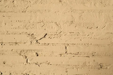 Texture of white painted brick wall close-up with sun. Stock Photos