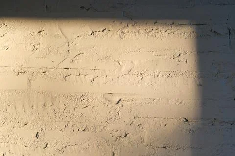 Texture of white painted brick wall close-up with sun. Stock Photos