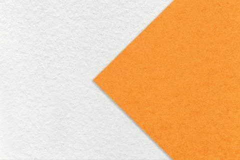 Texture of white paper background, half two colors with orange arrow, macro. Stock Photos