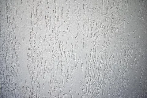The texture of the white wall - decorative plaster. Stock Photos