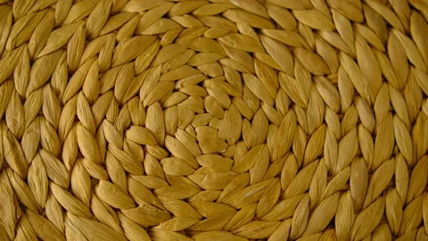 The texture of a wicker basket. The wicker mat swirls. Straw color. Background.  Stock Footage 147623273