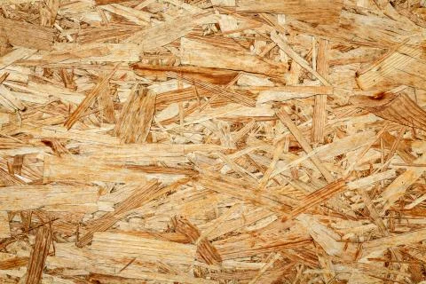 The texture of the wooden surface of pressed chips and sawdust closeup. Stock Photos