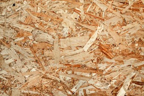The texture of the wooden surface of pressed chips and sawdust closeup. Stock Photos