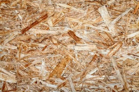 The texture of the wooden surface of pressed chips and sawdust closeup. Stock Photos