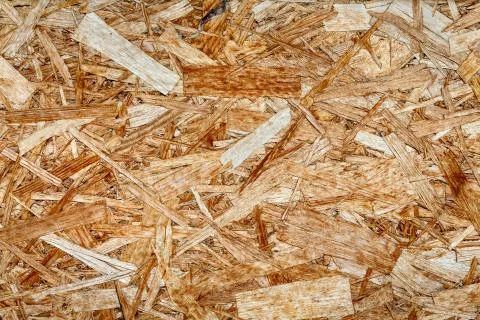 The texture of the wooden surface of pressed chips and sawdust closeup. Stock Photos