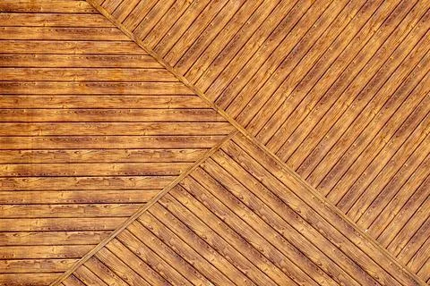 Texture of a wooden wall with a geometric pattern of boards. background, clos Stock Photos