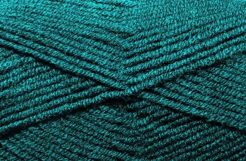 The texture of the wool blend yarn is dark turquoise. Stock Photos