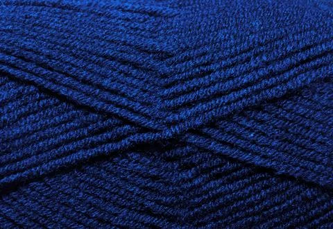 The texture of the wool blend yarn is dark blue. Stock Photos
