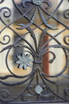 The texture of the wrought-iron grille on the window.Close. Artistic forging Stock Photos