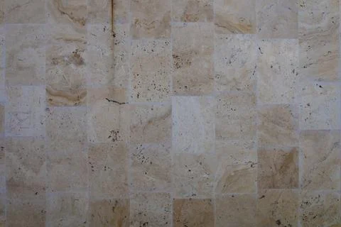 Texture of a yellow and brown colored stone wall background Stock Photos