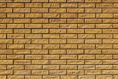 Texture of a  yellow brick wall background 写真素材