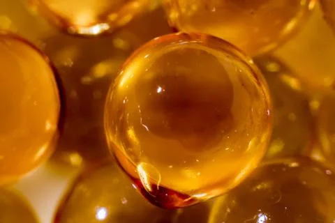 A texture of yellow bubbles is obtained from spherical capsules of fish oil Stock Photos