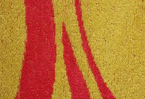 Texture of yellow fabric with red patterns Stock Photos