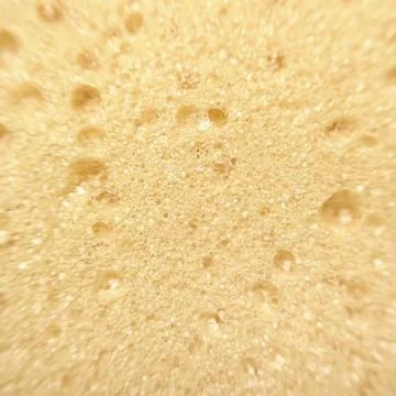 Texture of the yellow kitchen sponge background Stock Photos