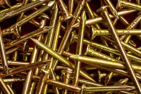 Texture of yellow nails on red background. 스톡 사진