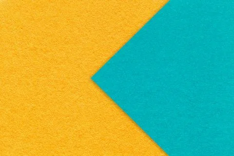 Texture yellow paper background, half two colors with turquoise arrow, macro. Stockfoto's