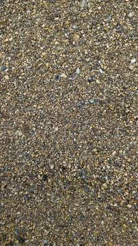 Texture of yellow sand with small pebbles. Sand pattern Stockfoto's