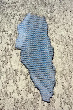 Textured and structural plaster of bark with a crack and a fallen off piece. Stock Photos