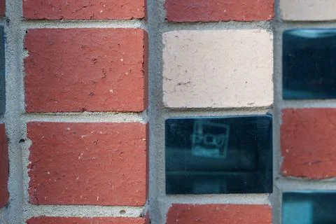 Textured architectural wall featuring reddish-brown bricks, light beige blo.. Stock Photos