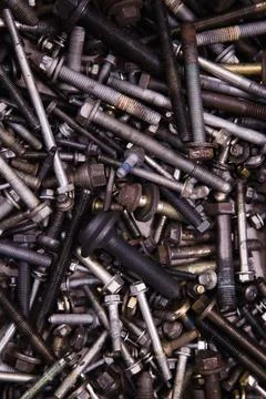 A textured backdrop of assorted bolts and screws in varied sizes Stock Photos
