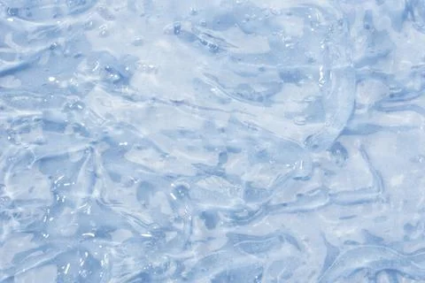 Textured backdrop of turquoise colored clear rippling water surface on beach Stock Photos