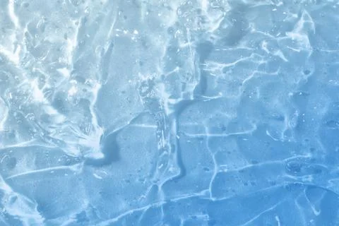 Textured backdrop of turquoise colored clear rippling water surface on beach Stock Photos