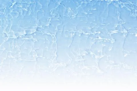 Textured backdrop of turquoise colored clear rippling water surface on beach Stock Photos