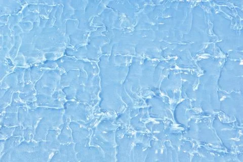 Textured backdrop of turquoise colored clear rippling water surface on beach Stock Photos
