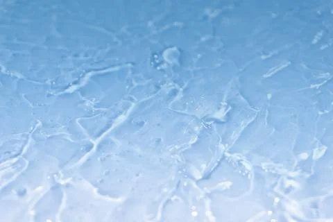 Textured backdrop of turquoise colored clear rippling water surface on beach Stock Photos