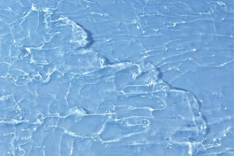 Textured backdrop of turquoise colored clear rippling water surface on beach Stock Photos