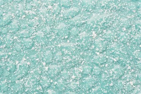 Textured backdrop of turquoise colored clear rippling water surface on beach Stock Photos