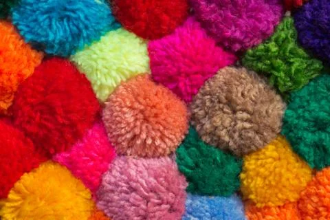 Textured background of assorted and multicolored wool pom poms Stock Photos