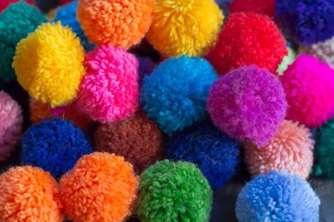 Textured background of assorted and multicolored wool pom poms Stock Photos