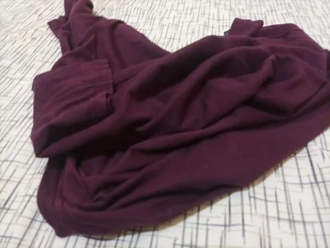 Textured background featuring a deep maroon or burgundy fabric Stock-Fotos