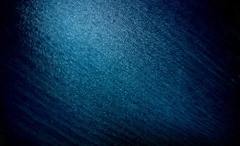 A textured background featuring a gradient of deep blue tones. The surface .. Illustrazione stock