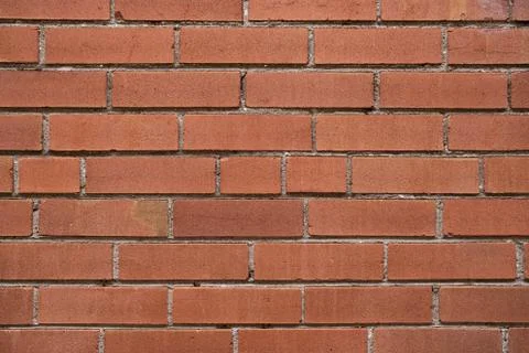 A textured background image of a red brick wall Stock Photos