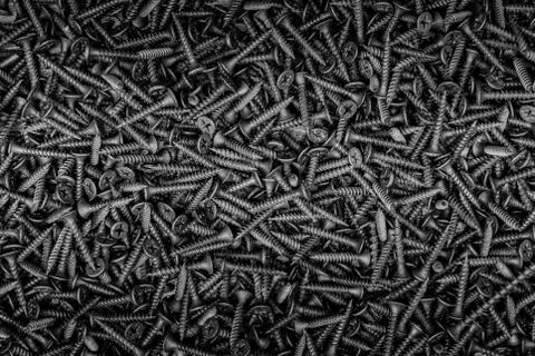 Textured background made of self-tapping screws in black and white. Foto stock