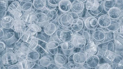 Textured background made of transparent plastic cups in blue tone. Industrial Foto stock