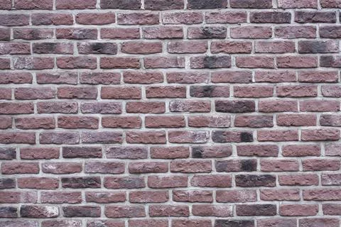 Textured background of an old dark red brick wall Foto stock