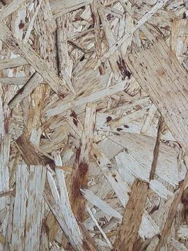 Textured background of oriented strand board panel. Stock Photos