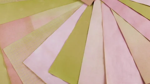 A textured background of rotating vintage paper in pink, soft pink, peach. Stock Footage 330274682