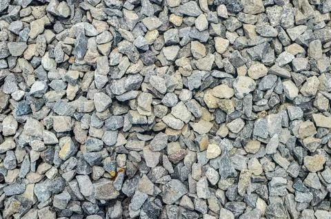 A textured background of small gray rocks or gravel. Stock Photos