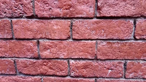 Textured Background of a Solid Red Brick Wall Facing Stock Footage 336706079